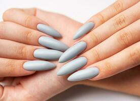 Woman's hand with grey nail polish photo