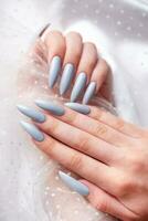 Grey nails on white lace background. photo