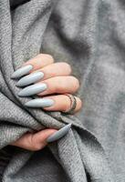 Grey manicure nails with a grey scarf photo