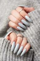 Woman's hand with grey nail polish photo