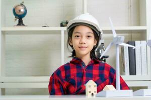 Kid learning about renewable energy, Child girl how wind turbines work photo