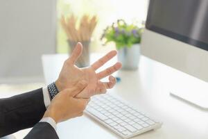 Man suffering pain in hands and fingers, Unhealthy office man hand injury photo