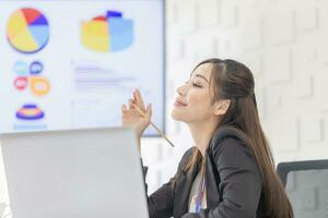 Portrait of Smiling woman working on laptop in a meeting room photo