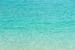 Tropical summer beach and transparent blue sea water background. photo