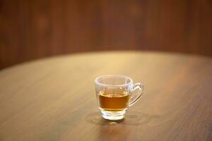 Cup of Lingzhi mushroom hot tea on table. photo