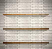 Empty wood shelves on white brick background. photo