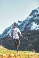 Man during endurance training with poles photo