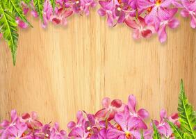 Old wooden background with pink Orchid flowers frame photo