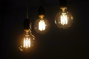 incandescent light bulb on dark background photo