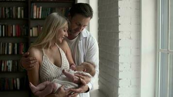 Husband and wife rocking their newborn baby in their arms video