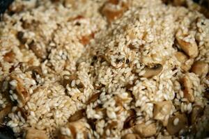 Process of cooking risotto in frying pan photo