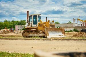 Yellow bulldozer at construction site photo
