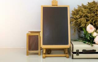 Mock up of Blank chalkboard or blackboard on white wall and vintage object. photo