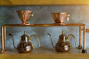 Metal copper coffee dripers and kettle photo