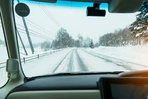 Beautiful snow road forest view during car driving in winter season. Winter travel, Road trip, Adventure, Exploring and Vacation concepts photo