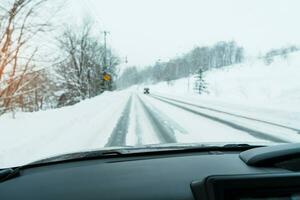 Beautiful snow road forest view during car driving in winter season. Winter travel, Road trip, Adventure, Exploring and Vacation concepts photo