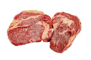 Two pieces of beef steak isolated on a white background. photo