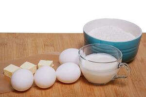 Ingredients for baking or making a dessert. Butter, flour and sour cream on the board. Cooking. photo