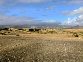 the desert is empty and has a few rocks photo