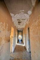 the hallway of an old building with peeling paint photo
