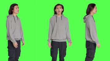 Young uncertain adult shrugging on camera, doing i dont know gesture after earing question. Person feeling clueless and unsure over greenscreen background, doubtful guy. video