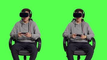 In studio, asian man enjoys phone game with virtual reality glasses, competing in online rpg using mobile vr software on headset. Young adult player enjoying good time with his friends. video