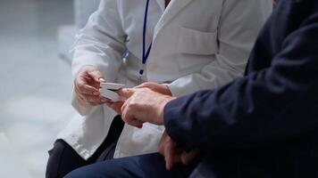 Close up of specialist clipping patient finger using pulse oximeter, monitoring level of blood oxygen saturation and heart rate during consultation in chemist store offering full range of services photo