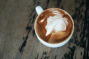 coffee latte art on the wooden desk photo