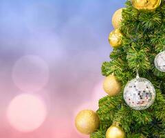 Christmas tree with ball decoration on pastel bokeh photo