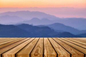 Brown wooden plank on layer colorful mountain photo