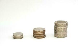 Stack coins growing or saving on white background photo