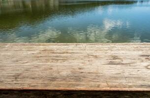 Wood table top on lake natural photo