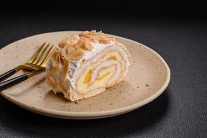 A piece of delicious sweet meringue roll with mascarpone cheese, berries and almonds photo