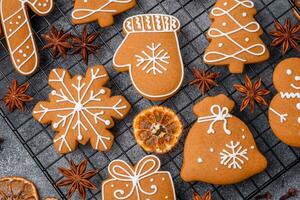 Beautiful delicious sweet winter Christmas gingerbread cookies on a gray textured background photo