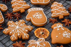 Beautiful delicious sweet winter Christmas gingerbread cookies on a gray textured background photo