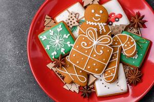 Beautiful delicious sweet winter Christmas gingerbread cookies on a gray textured background photo