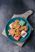 Beautiful delicious sweet winter Christmas gingerbread cookies on a gray textured background photo