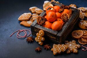 Beautiful festive Christmas composition of tangerines, gingerbread and star anise photo