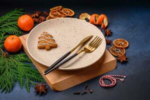 Beautiful festive Christmas composition of an empty plate, tangerine and gingerbreads photo