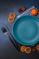 Beautiful festive Christmas composition of an empty plate, tangerine and gingerbreads photo