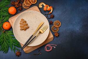 Beautiful festive Christmas composition of an empty plate, tangerine and gingerbreads photo