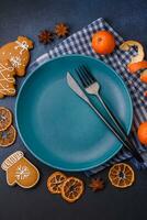 Beautiful festive Christmas composition of an empty plate, tangerine and gingerbreads photo