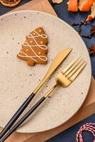 Beautiful festive Christmas composition of an empty plate, tangerine and gingerbreads photo