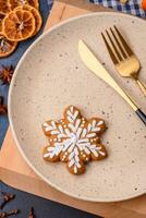 Beautiful festive Christmas composition of an empty plate, tangerine and gingerbreads photo