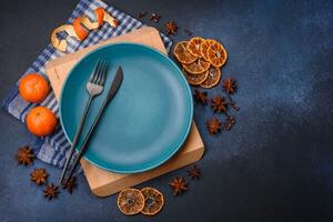 Beautiful festive Christmas composition of an empty plate, tangerine and gingerbreads photo