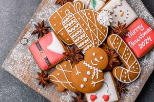 Beautiful delicious sweet winter Christmas gingerbread cookies on a gray textured background photo