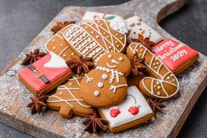 Beautiful delicious sweet winter Christmas gingerbread cookies on a gray textured background photo