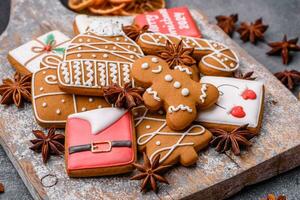 Beautiful delicious sweet winter Christmas gingerbread cookies on a gray textured background photo