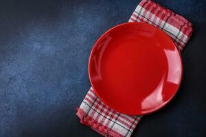 Round empty colored ceramic plate on concrete texture background photo