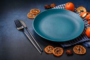 Beautiful festive Christmas composition of an empty plate, tangerine and gingerbreads photo